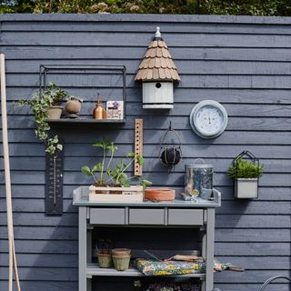 Dark grey fence in front of potting bench