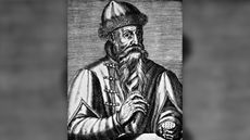 Black and white engraving of Johannes Gutenberg. He is wearing a hat and coat and has a long beard.