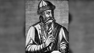 Black and white engraving of Johannes Gutenberg. He is wearing a hat and coat and has a long beard.