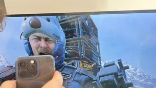 Sam Porter Bridges from Death Stranding looking at a phone and screaming