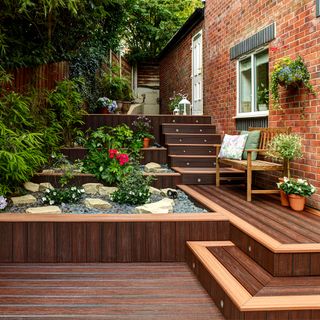deck area with wooden bench and flower plants