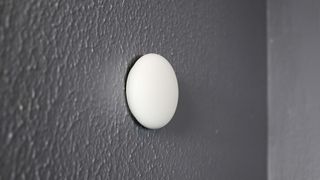 The included Nest Temperature Sensor (2nd Gen) that comes with the Nest Learning Thermostat (4th Gen) installed on a wall