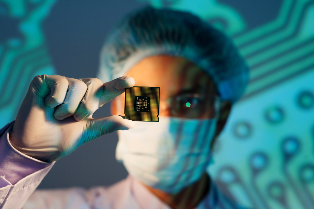 Stock image of engineer holding chip