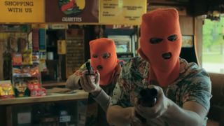 Two masked robbers wearing orange masks during the Hulu show, Reservation Dogs.