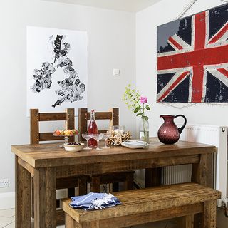 wooden table and chair and flag on wall