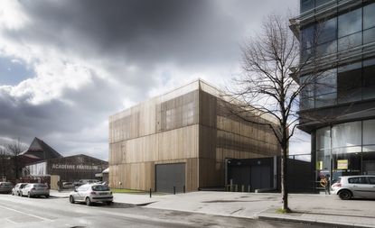 Brown building with grey clouds in background