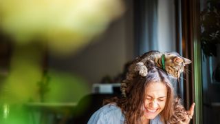 woman laughing with cat
