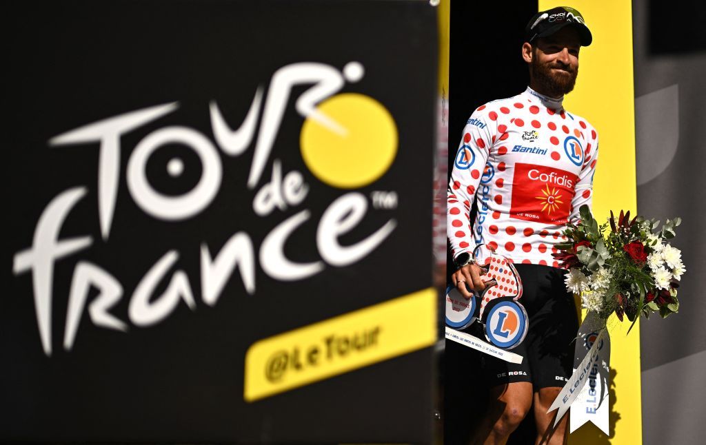 Cofidis teams German rider Simon Geschke celebrates on the podium with the climbers dotted jersey after the 9th stage of the 109th edition of the Tour de France cycling race 1929 km between Aigle in Switzerland and Chatel Les Portes du Soleil in the French Alps on July 10 2022 Photo by Marco BERTORELLO AFP Photo by MARCO BERTORELLOAFP via Getty Images