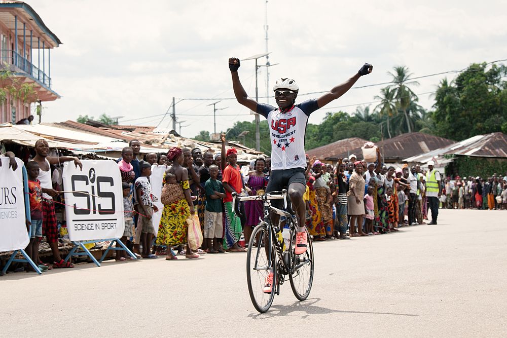 Ibrahim Kamara celebrates victory in the junior race in a jersey donated by USA Cycling