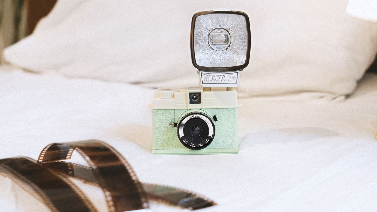 The Lomography Half-Frame Lomourette lifestyle image on a bed with film