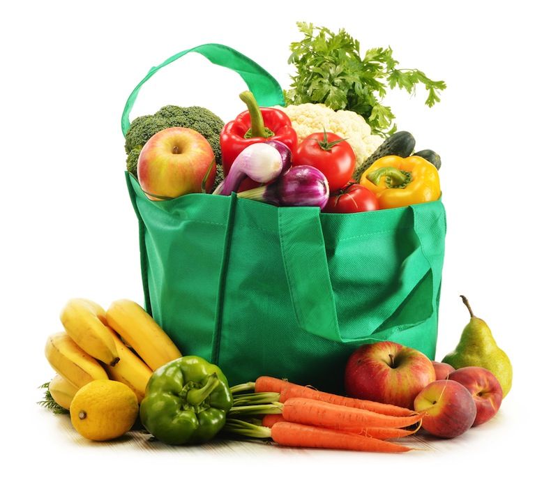 A canvas grocery bag full of fruit and vegetables