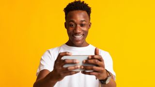 A man playing games on his smartphone