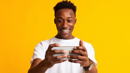 A man playing games on his smartphone