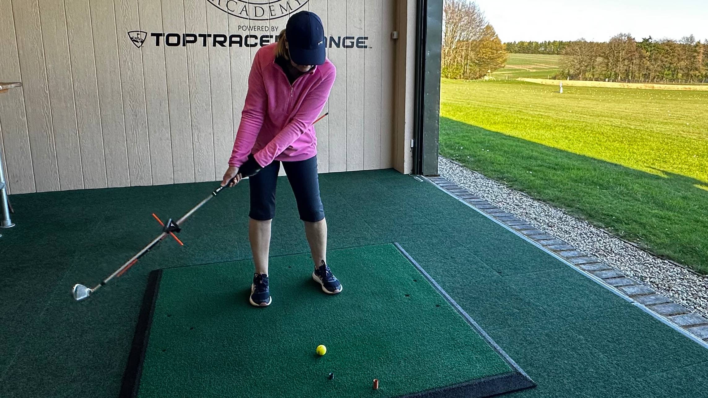 Female golfer using V Plane training aid
