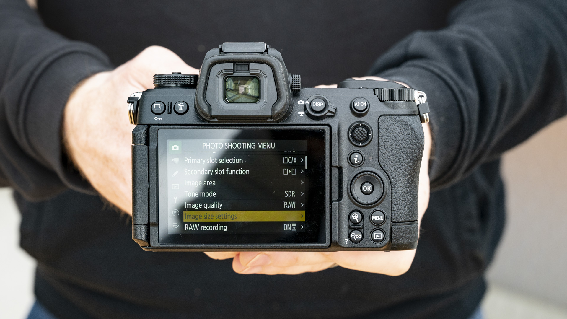 Nikon Z6 III camera in the hand, rear touchscreen