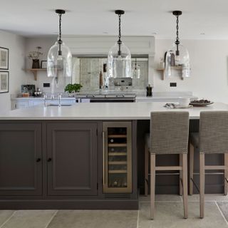 dark grey Shaker kitchen with large kitchen island with oversized glass pendants