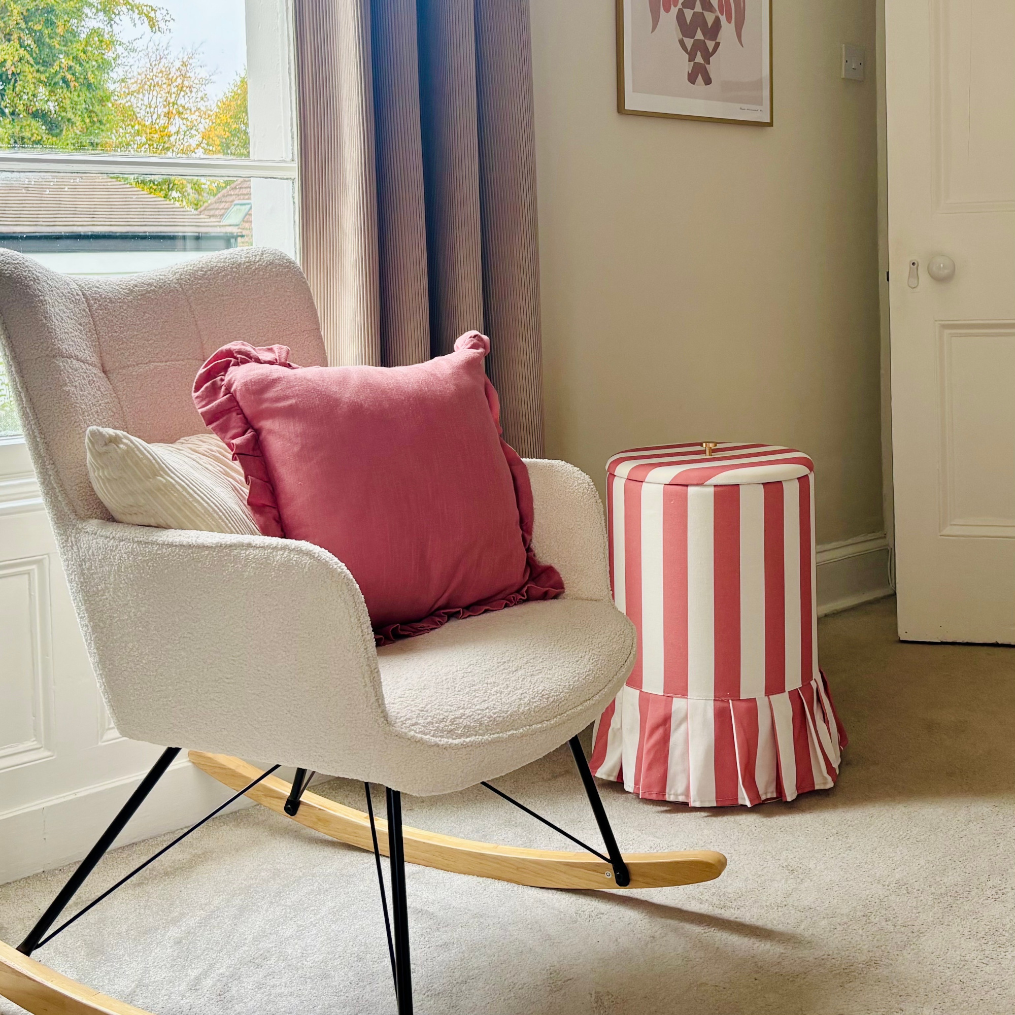 next striped frill laundry hamper in a bedroom with rocking chair