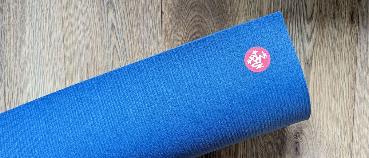 Manduka PRO yoga mat on a wooden floor