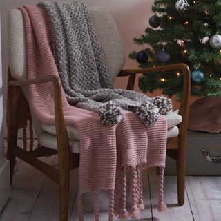 pink and grey throw on chair and christmas tree