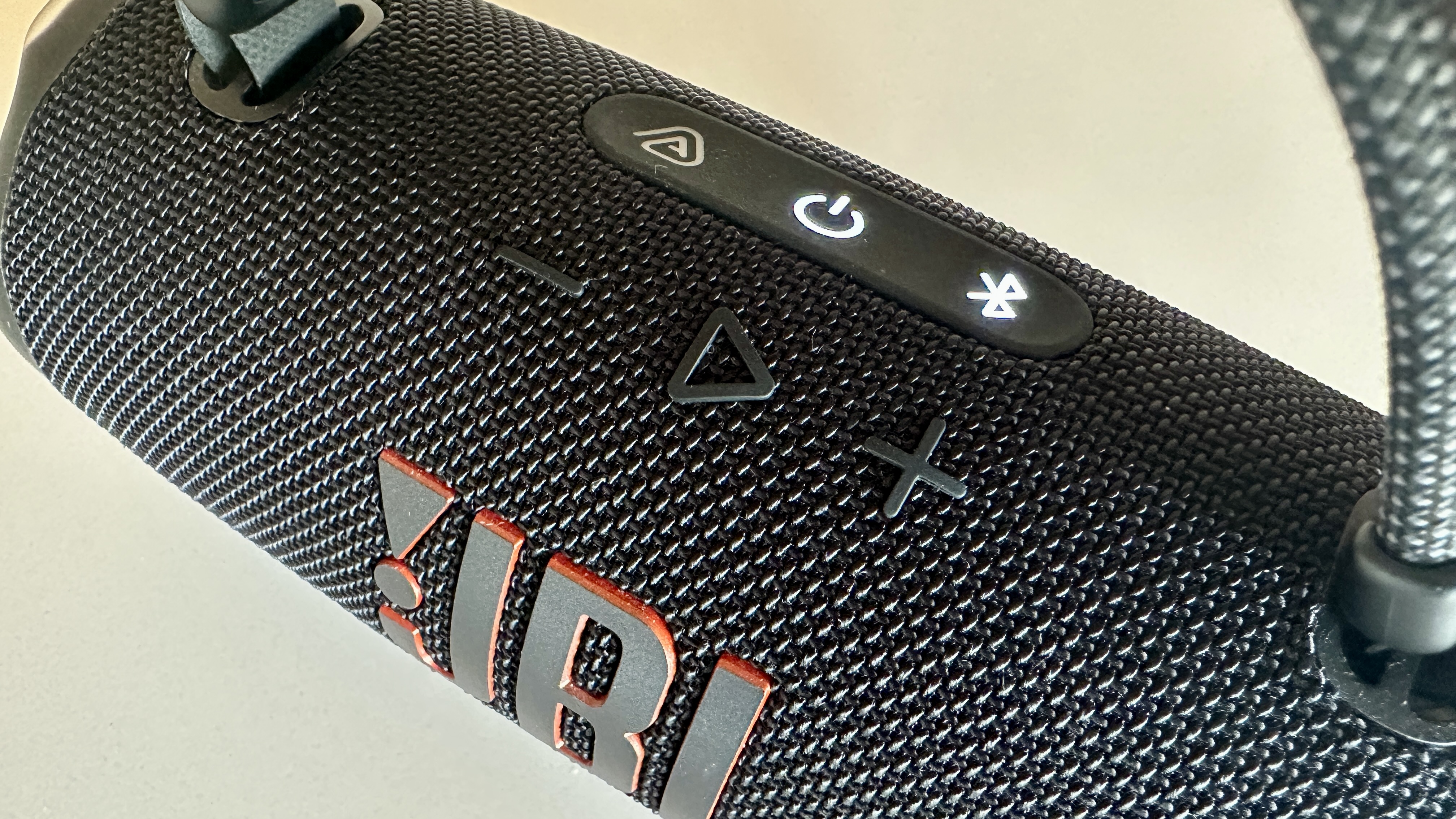 The JBL Charge 6 viewed from the top, showing its controls and logo
