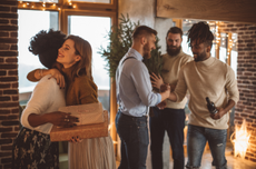 guests bring gifts to a holiday party