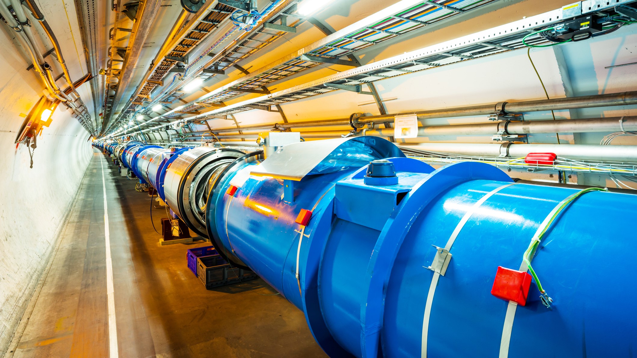 Photograph of a long tunnel containing the Large Hadron Collider.