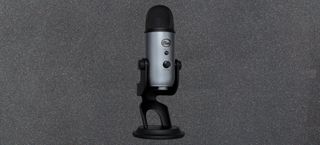 blue yeti usb microphone against gray background