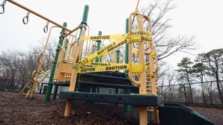 Access to children&#039;s playground equipment is taped off on March 30, 2020 in Oyster Bay on Long Island, New York, amid the coronavirus pandemic..