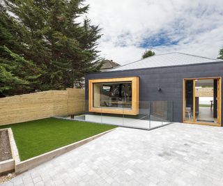 grey self build with small driveway and front lawn