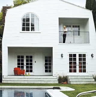 house exterior white wall white window and door pool garden and balcony