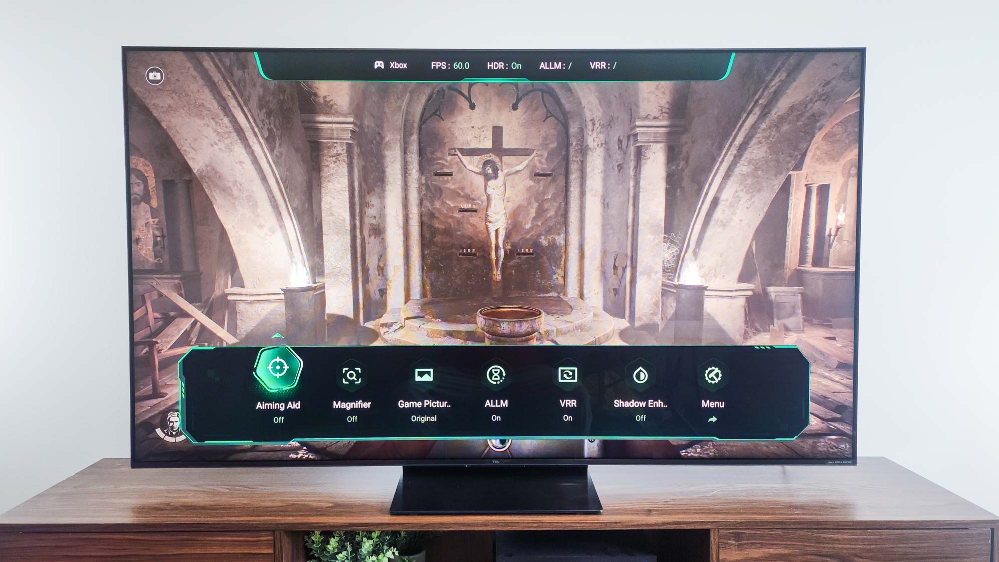 A TCL QM7K QD-Mini LED TV on a side table