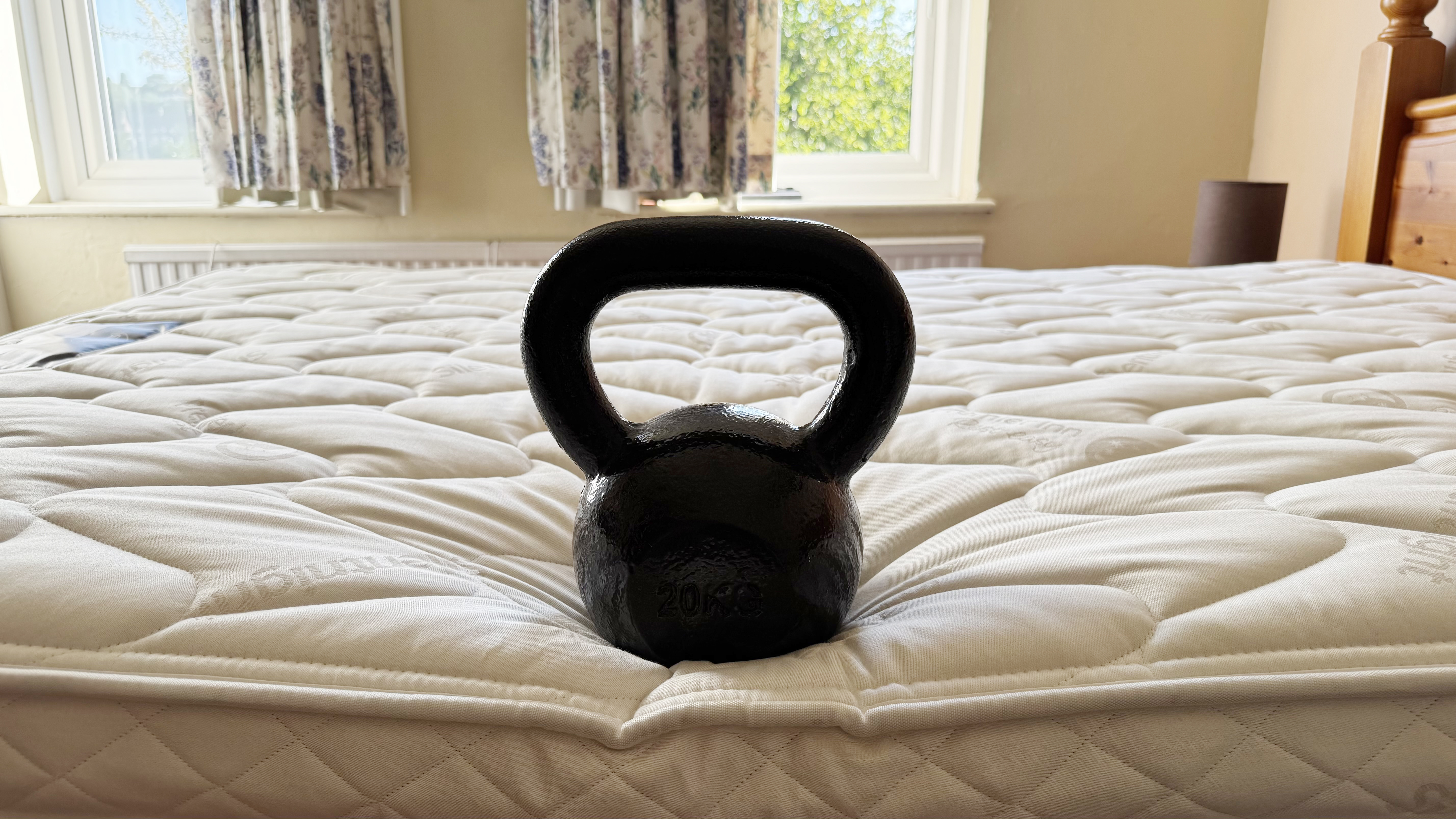 A large weight on the edge of the Premier Inn mattress