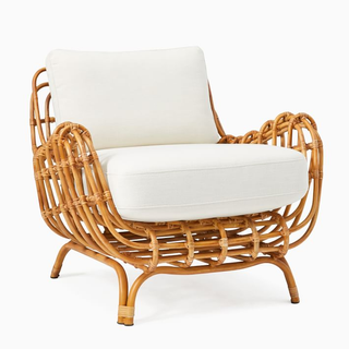accent chair with rattan frame and white cushion