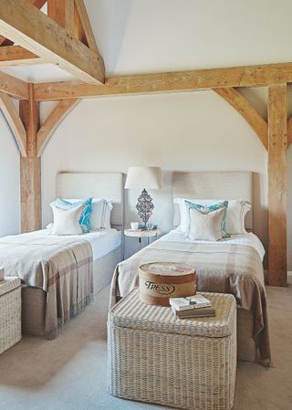 twin bedroom with wooden beams and natural wicker baskets