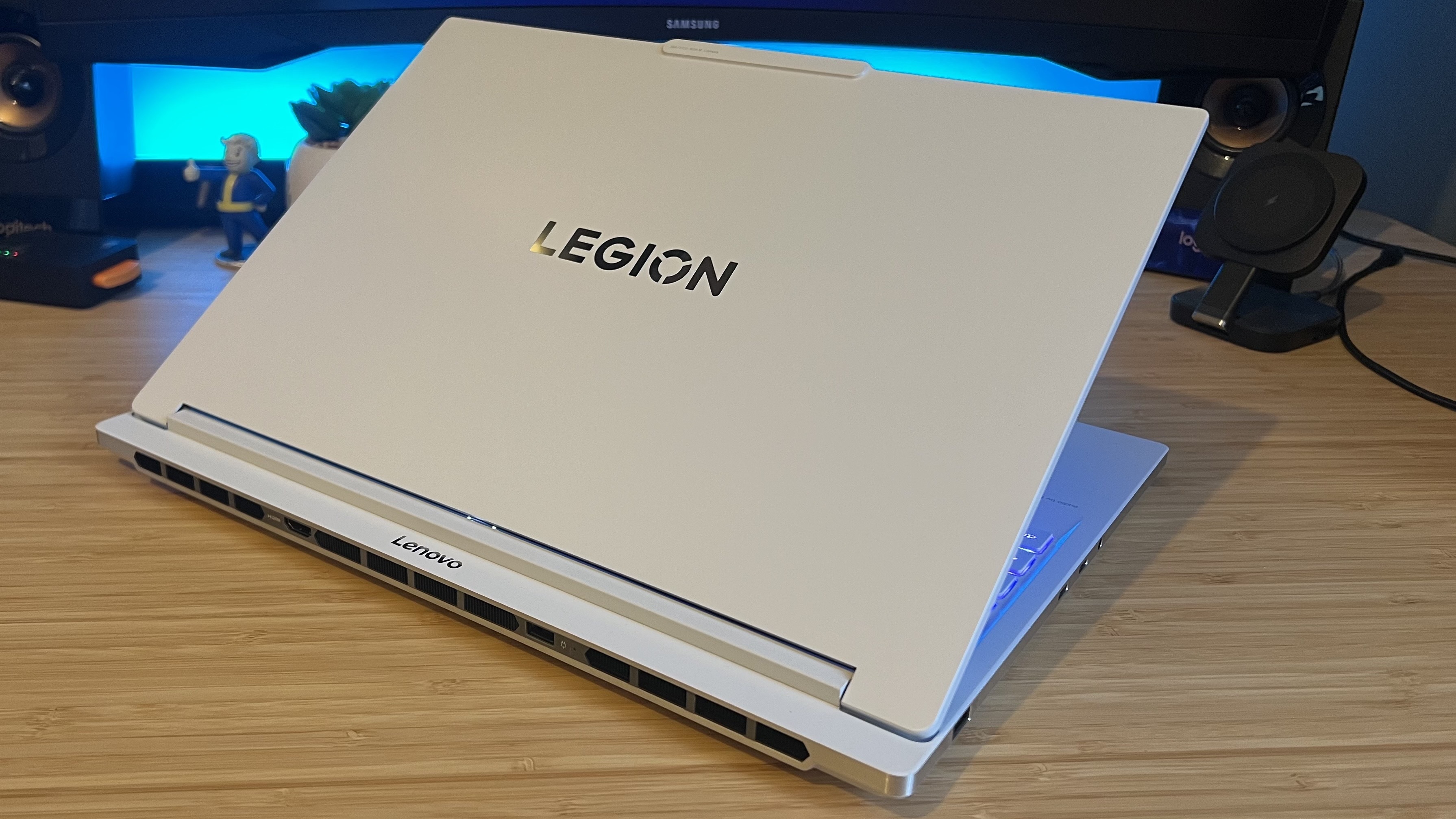 Back of Lenovo Legion 7 Gen 10 top lid while gaming laptop is half closed on a wooden desk