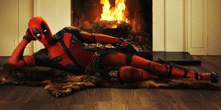 Deadpool lounging in front of the fireplace