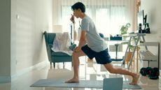 Man in a lunge position in a domestic setting