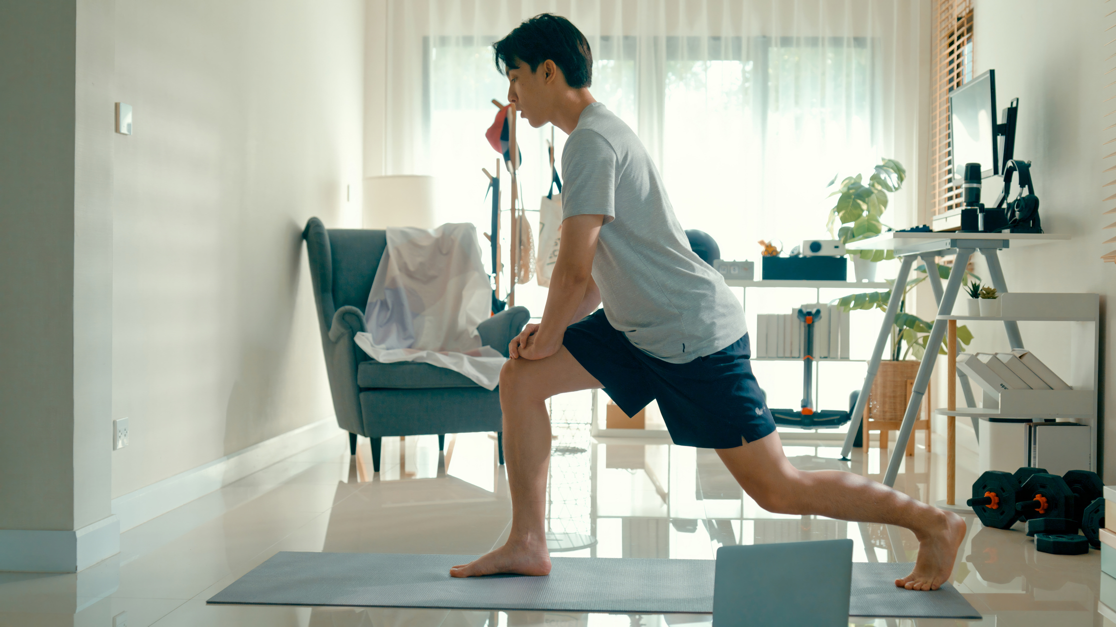 Man in a lunge position in a domestic setting