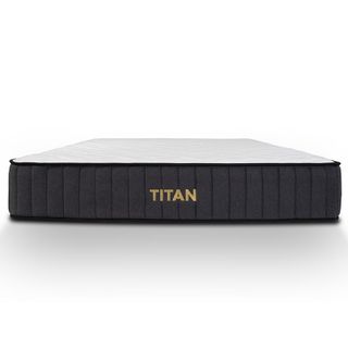 The Titan Plus mattress shown with a grey base and white cover
