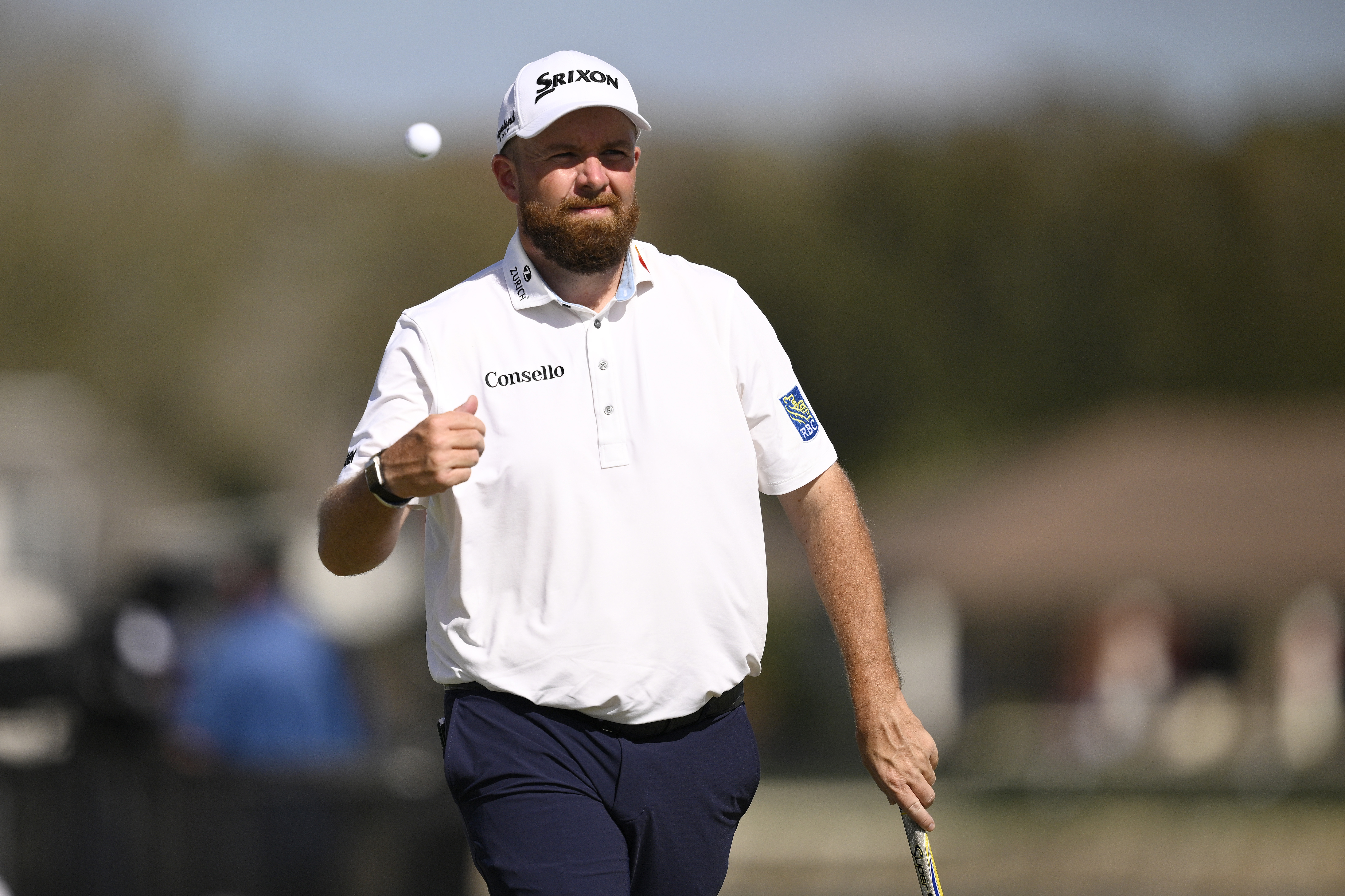Shane Lowry throws his golf ball in the air