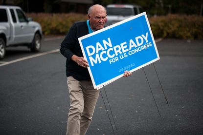 A man holds a sign for Dan McCready.