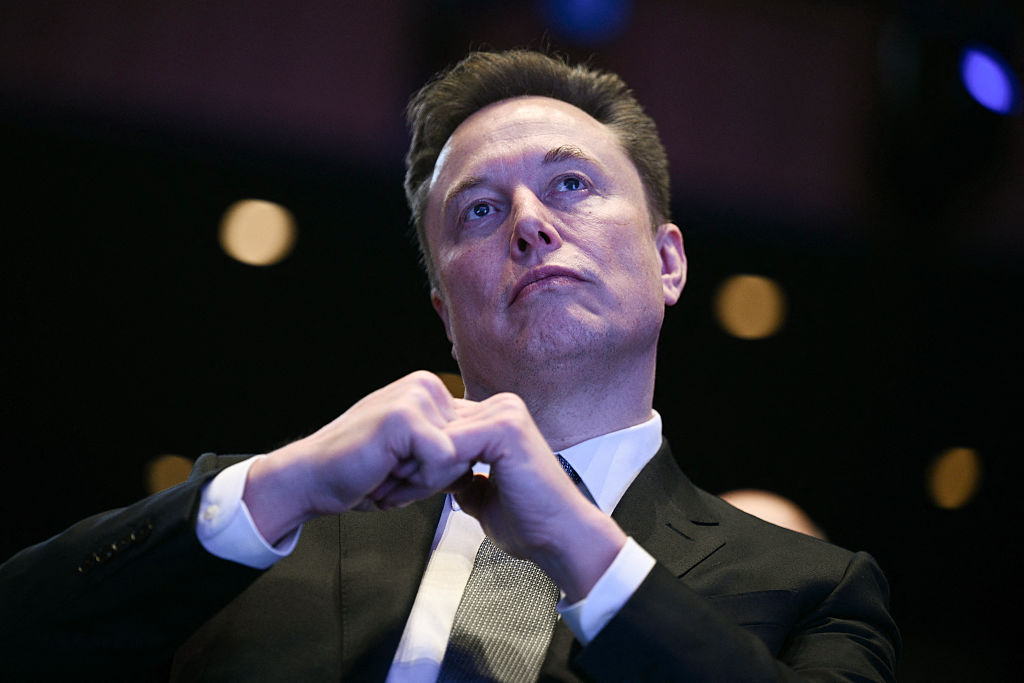Elon Musk looks on