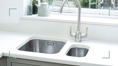 white kitchen with double stainless steel sinks sunk into the countertops to support a guide on how to clean a kitchen sink drain without chemicals