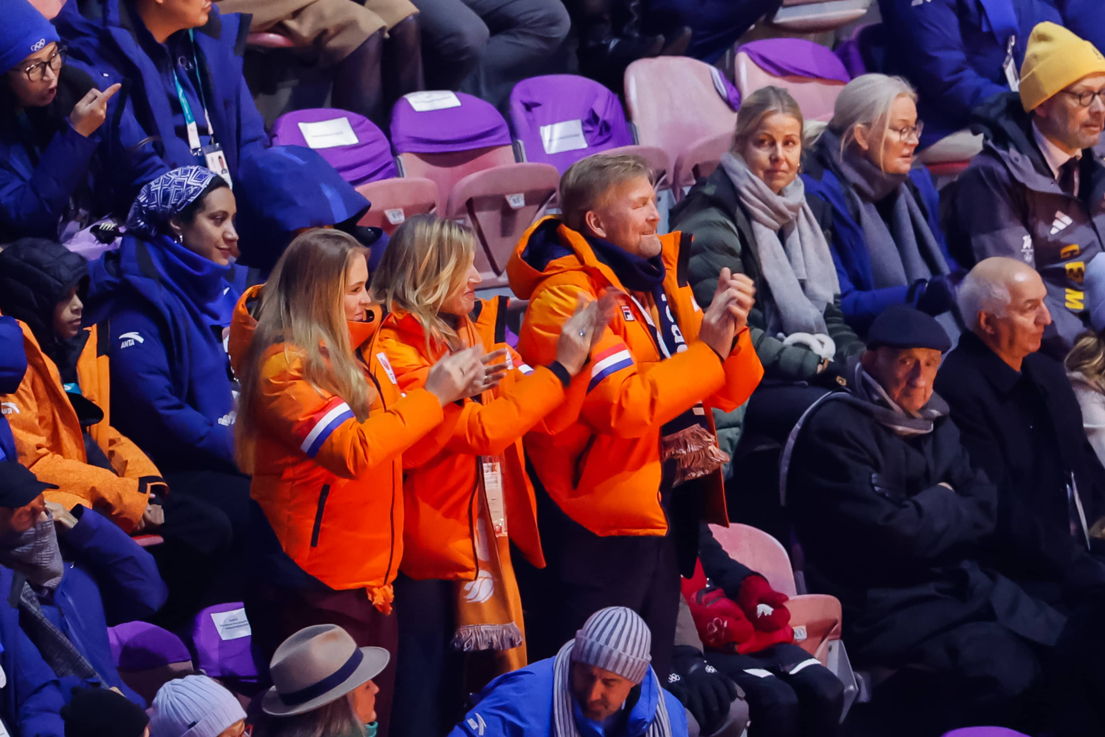 Princess Amalia, Queen Maxima, and King Willem-Alexander wearing orange coats at the Olympic opening ceremony