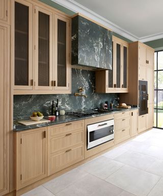 Martin Moore Legacy kitchen with oak doors and a Olivo Verde granite splashback and worktop