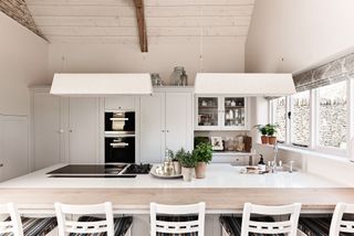 miniamlist white country kitchen with versatile peninsula