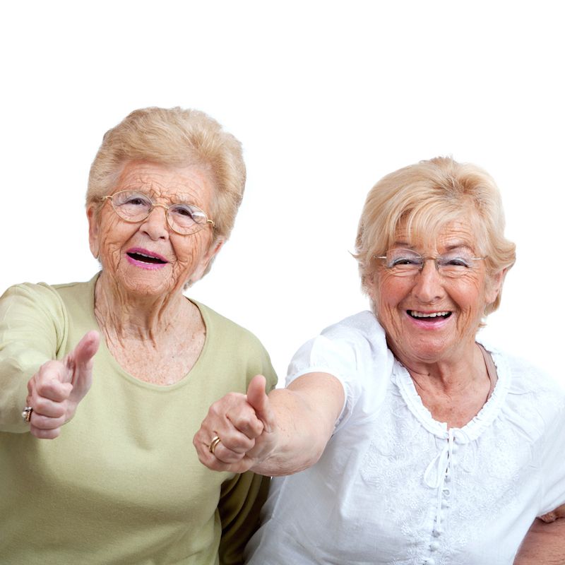 Older women giving thumbs up