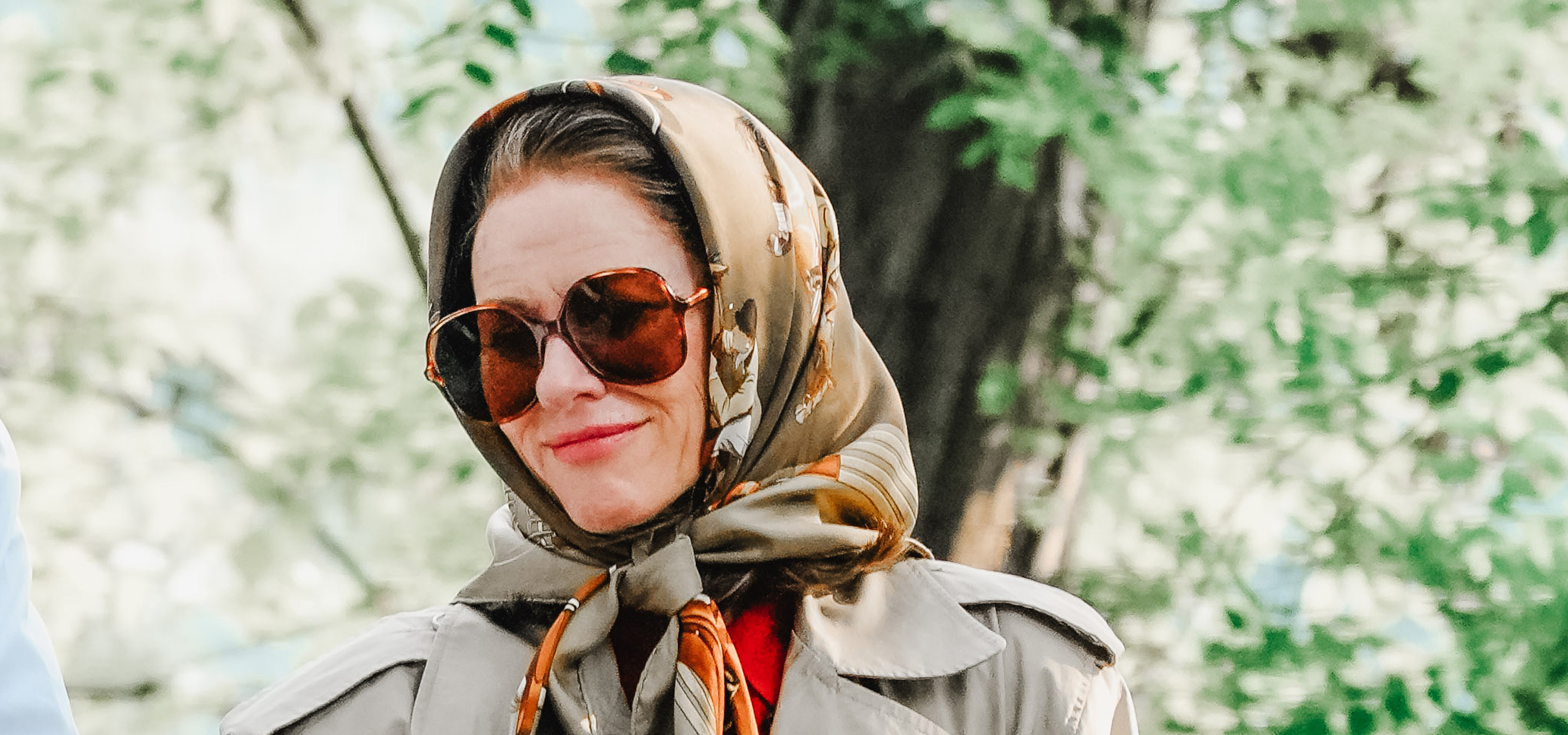 Naomi Watts on set for American Love Story wearing a silk scarf and oversized sunglasses