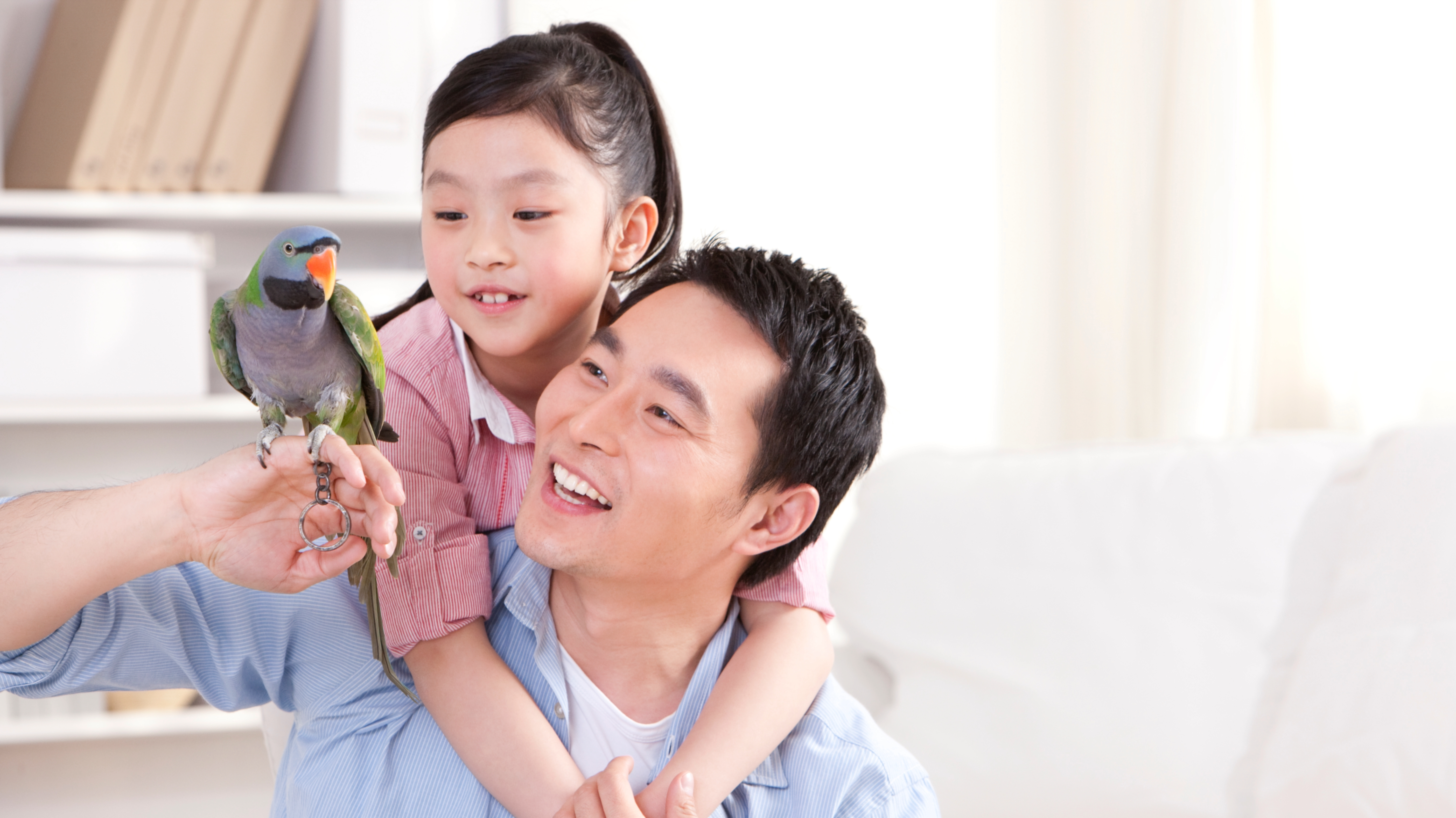 Father and daughter with pet bird