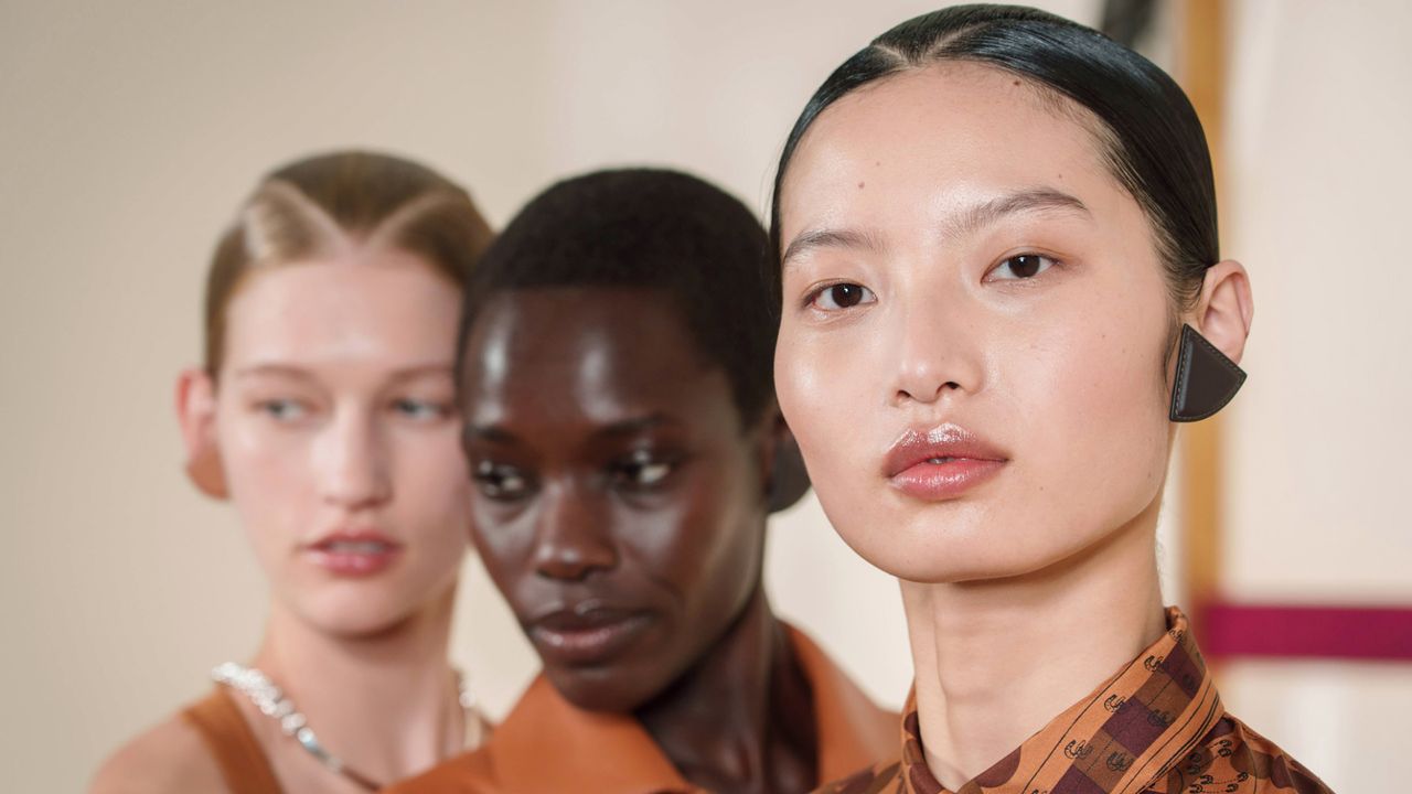 models backstage at hermes spring 2025 show with fresh glowy shkin 